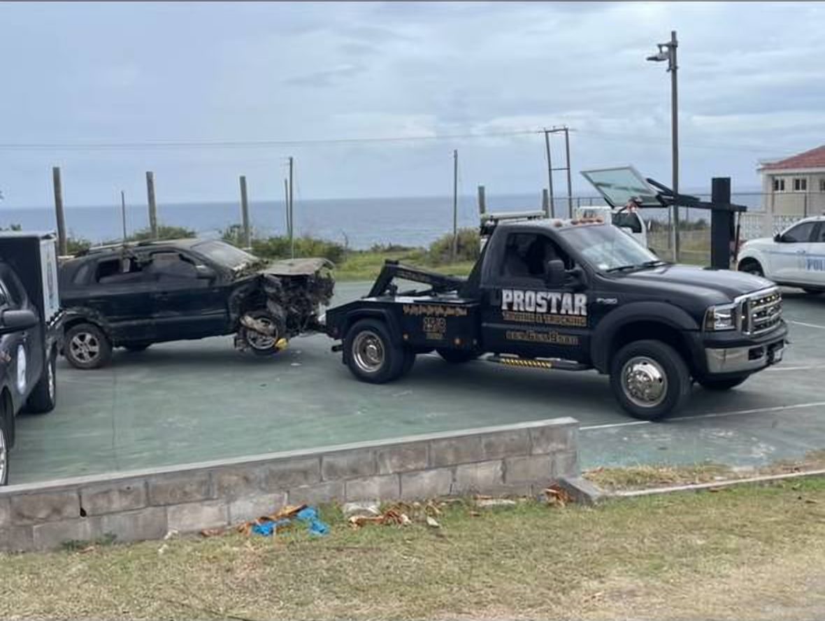 The ProStar wrecker towing a crashed SUV by the sea on St. Kitts