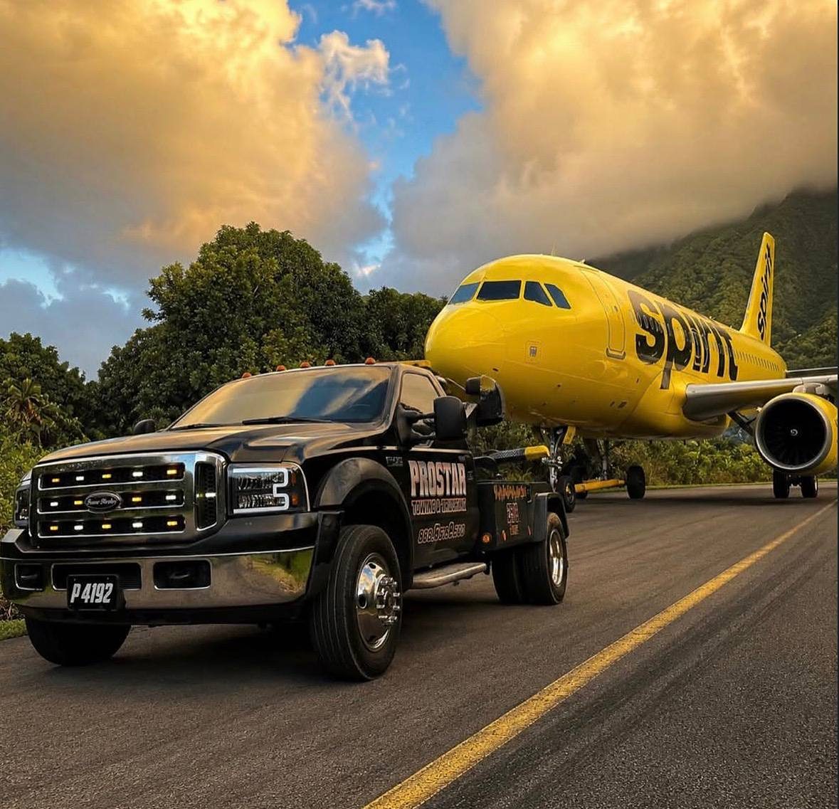 The ProStar wrecker parked on an airport runway under golden clouds